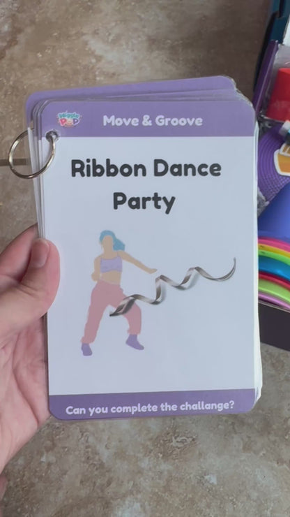 video showing what is inside the activity box which includes a dance ribbon, cones, scarfs, floor dots, bubble wand, play prompt cards